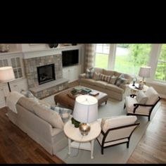 a living room filled with furniture and a fire place in the middle of a room