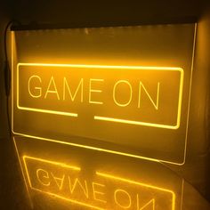 a neon sign that reads game on