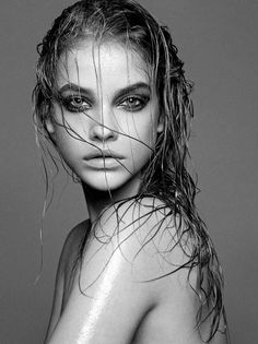 a woman with wet hair is posing for the camera