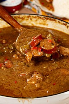 a spoon full of soup with meat and vegetables