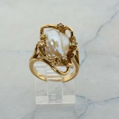 14K Yellow Gold Pearl and Diamond Ring, interesting asymmetrical design, Ring size 6.5, 8.7 grams Stock # R00070 This listing contains photographs of the actual item you will receive.  Our items are in excellent condition with little or no signs of wear and many are one of a kind pre-owned estate finds.   Please look closely at the pictures in this listing as they are part of the product description. Please read the description, as any imperfections or condition comments will be included.  We do our best to accurately describe the condition of each piece and encourage you to ask questions prior to purchase.    We are happy to address any questions you may have.  Please contact us.  Our Store has many other items for sale.  We specialize in fine & designer jewelry, watches & more.    Coloni Pearl And Gold Jewelry Aesthetic, Inlaid Engagement Rings, Vintage Italian Engagement Rings, Antique Engagement Rings Vintage 1920s Gold, Art Nouveau Engagement Ring Antique, Gold Pearl Wedding Ring, Gold Engagement Ring With Silver Band, Pearl And Gold Engagement Ring, Evorden Rings