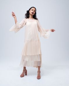 This effortless silk chiffon dress features a romantic double layer cascade in the bodice and sleeve, and a stretch oval neckline that can be worn over the shoulder. Wear it loose as a whimsical party dress, or belt it for a sleek cocktail look. Handmade in New York. 100% silk chiffon Model is wearing a size S and is 5'10" Product Care: Dry Clean Only Flowy Maxi-length Chiffon Cocktail Dress, Flowy Maxi Cocktail Dress, Flowy Maxi Length Cocktail Dress, Flowy Chiffon Dress With Sheer Sleeves, Flowy Chiffon Maxi Dress For Cocktail, Flowy Chiffon Maxi Dress For Cocktail Occasions, Chiffon Evening Dress With Flowy Skirt, Evening Chiffon Dress With Flowy Skirt, Elegant Ruffled Chiffon Dress For Spring