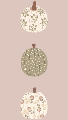 three pumpkins with floral designs on them, one is green and the other is white