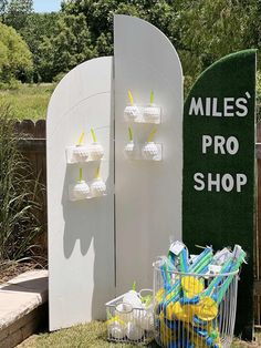 a sign that says miles'pro shop next to a basket with toothbrushes in it