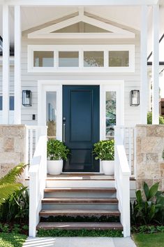 a blue front door on a white house