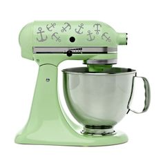 a green kitchen mixer with the word love written on it's front and side