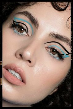 a woman with blue eyeliners on her face