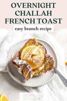 a white plate topped with french toast covered in powdered sugar and sliced oranges