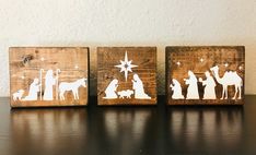 three wooden blocks with nativity silhouettes on them