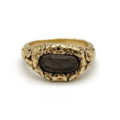 An early nineteenth century gold mourning ring featuring a heavily carved floral pattern throughout and centering an oval compartment with a plait of braided brown hair, engraved to the reverse: W. H. Crowder ob. 3 Mar. 1816 aet 21 (W. H. Crowder died 3 Mar 1816 age 21), size 6 and not sizable, 6.0 grams.  During the early nineteenth century it was common for women to adorn themselves with multiple rings of every shape and style, from amatory rings to mourning rings. As such, a rich diversity of Ceremonial Oval Cabochon Rings, Antique Carved Engraved Yellow Gold Ring, Antique Style Carved Engraved Yellow Gold Ring, Antique Carved Yellow Gold Engraved Ring, Antique Yellow Gold Engraved Carved Ring, Luxury Carved Yellow Gold Signet Ring, Luxury Oval Engraved Carved Ring, Formal Oval Carved Rings, Luxury Oval Engraved Ring With Intaglio