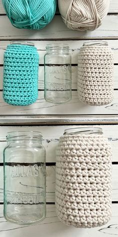 crocheted jars are lined up on the wall with balls of yarn in them