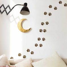 dog paw prints on the wall next to a lamp