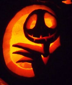 a pumpkin carved to look like a hand holding a jack - o'- lantern