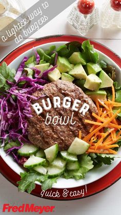 a burger bowl with lettuce, carrots and cucumber on it