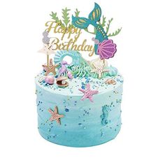 a birthday cake with blue frosting and sea animals on top, including an under the sea theme