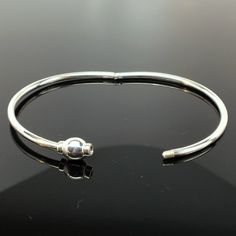 "This sterling silver Eternity Bangle is hinged to easily slip on the wrist. It features a threaded bead which completes the circle of eternity. The bangle can accommodate medium and large spacer beads, European style charm-beads, and traditional charms. Available in both sterling silver, and sterling silver with 14k gold vermeil. \"Sterling\" is inscribed on the inside of the band. Available in extra small, small, medium, and large. Extra small tends to fit a preschool girl or boy. Extra Small Adjustable Sterling Silver Bracelet With Box Clasp, Sterling Silver Bangle With Lobster Clasp, Adjustable Bangle Bracelet With Box Clasp, Sterling Silver Hinged Bracelet For Gift, Adjustable Bangle Bracelets With Box Clasp, Hinged Sterling Silver Bangle, Adjustable Sterling Silver Bracelet With Clasp, Adjustable Silver Bracelet With Clasp, Silver Bangle Bracelet With Clasp