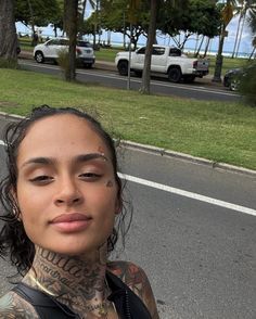 a woman with tattoos standing on the street