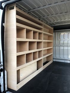 the inside of a white van with shelves in it