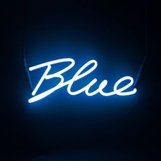 a blue neon sign that is on the wall