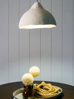 a plate with some food on it and a light hanging over the table in the background