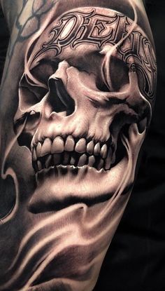 a man's arm with a skull and flames tattoo design on the back of it