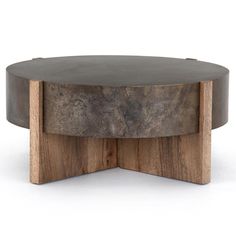 a round wooden table sitting on top of a white floor