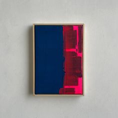 an abstract painting with red, blue and pink colors on a white wall above a wooden frame