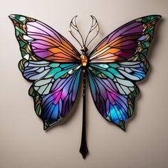 a colorful butterfly is hanging on the wall