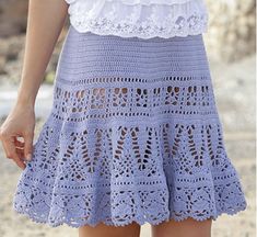 there is a woman wearing a blue crochet skirt