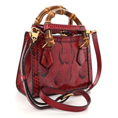 This is an authentic GUCCI Snakeskin Mini Diana Tote Bag in Red. This shoulder bag is crafted of snakeskin in red. The bag features a sturdy bamboo top handle, optional adjustable shoulder strap and an aged gold GG logo. The top opens to a beige leather interior. Bamboo Top, Gg Logo, Leather Interior, Gucci Bag, Snake Skin, Top Handle, Shoulder Strap, Bag Lady, Gucci