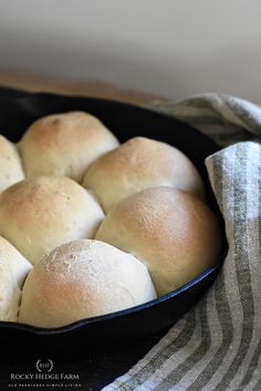 a pan filled with rolls sitting on top of a table