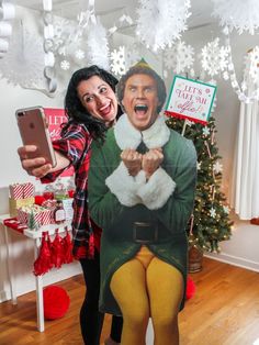 a woman taking a selfie with a giant christmas card in front of her face