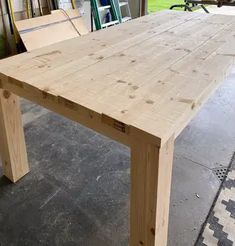 a wooden table sitting on top of a cement floor