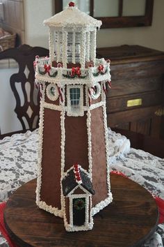 a cake shaped like a lighthouse on top of a table