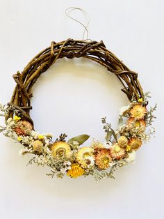 a wreath made out of branches and flowers