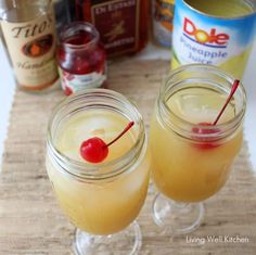 two glasses filled with lemonade and cherries