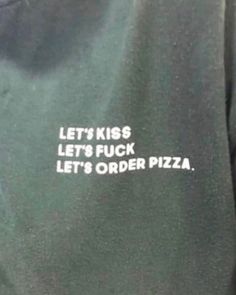 a person wearing a sweatshirt with the words let's kick, let's order pizza printed on it