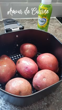 some red potatoes are in a colander on the counter