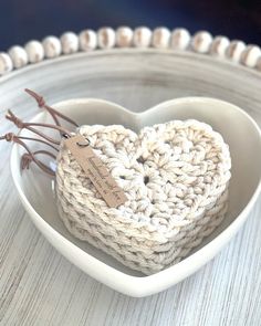 a crocheted heart in a white bowl