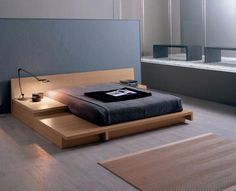 a bed sitting on top of a wooden platform next to a bath tub in a bathroom