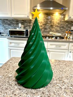 a green plastic christmas tree sitting on top of a counter next to a stovetop oven