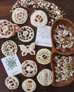 several different types of cookies are arranged on a table with cards and spoons next to them