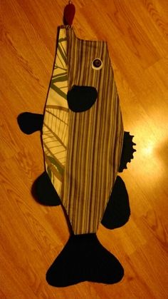 a fish shaped rug on the floor in front of a wooden floor with a light shining through it