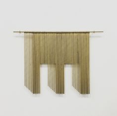 two pieces of wood are hanging on the wall, and one piece is made out of bamboo