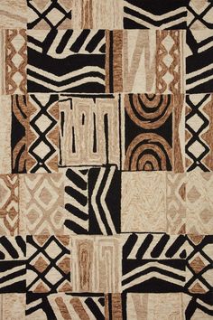 an area rug with many different designs on the side and black, white, beige, and brown colors