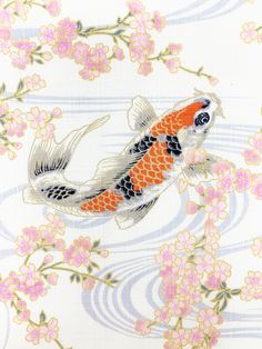 an orange and black koi fish floating on top of water surrounded by pink flowers