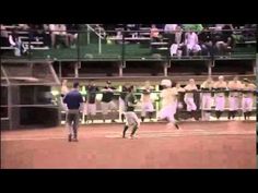 a baseball player swinging a bat on top of a field