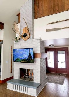 a living room with a fire place and television mounted on the wall