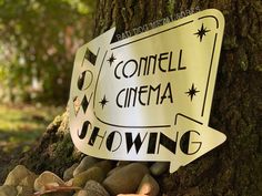 a sign on the side of a tree that says, comell cinema slowing down