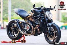 a black motorcycle parked on top of a street